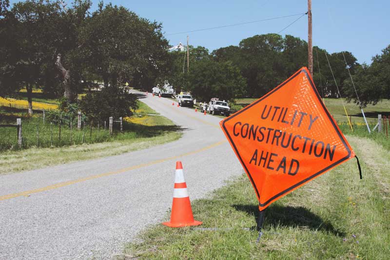 Image of crews working alongside road.